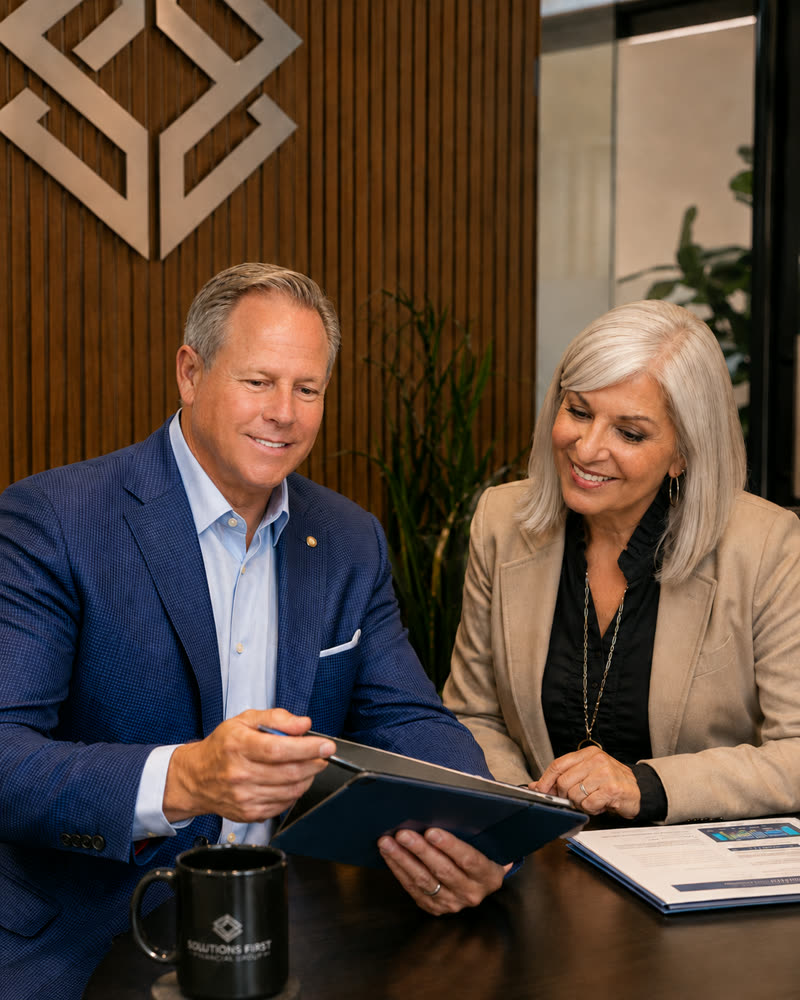 Joe and Patty Donti of Solutions First Financial Group standing together at their Scottsdale, Arizona office
