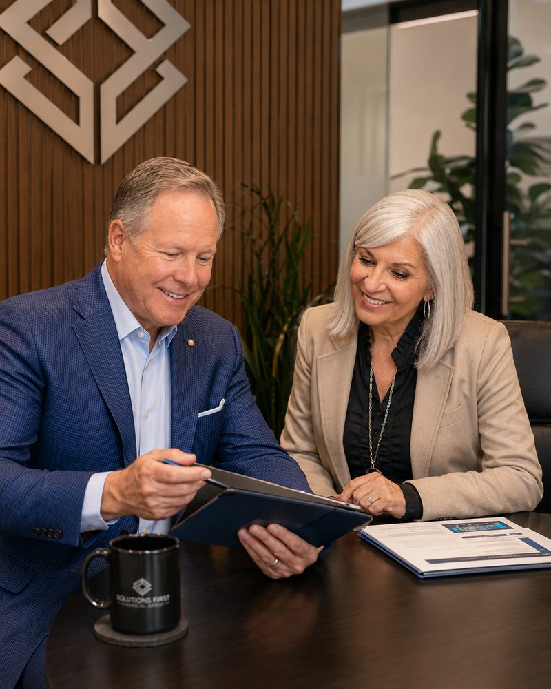 Joe and Patty Donti of Solutions First Financial Group standing together at their Scottsdale, Arizona office